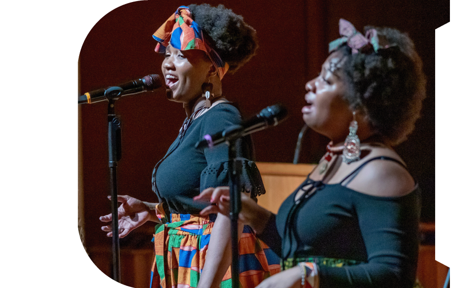 two people singing on stage