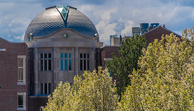 View of the Ritchie School Of Engineering 和 Computer 科学 with tree branches visible in the foreground.